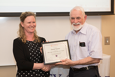 two people holding an award