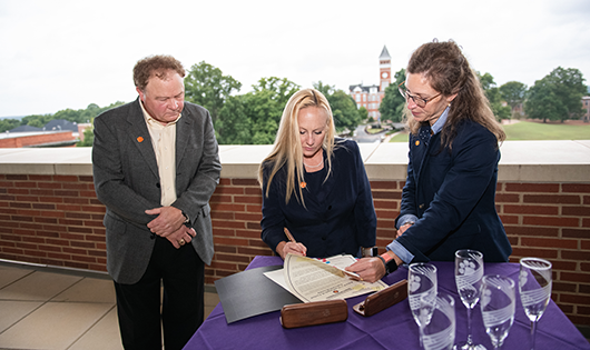 3 random people in an office signing important document