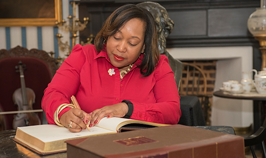 a lady signing a document