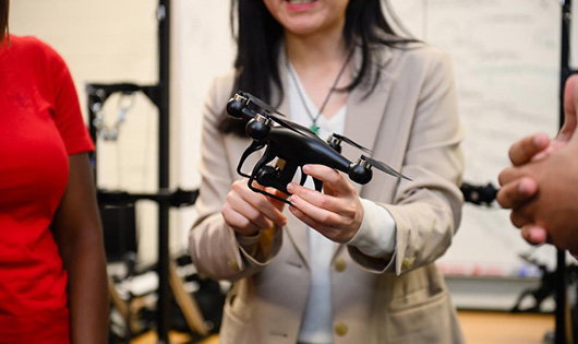 A female holding a device at 3D vision, career awards at CECAS
