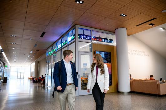 two people walking in a CU building