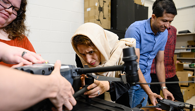 Faculty Fatemeh Afghah with 3 researchers in a lab
