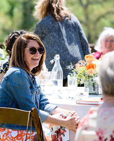 female smiling at palmetto cabinet meeting held on the botanical gardens ground