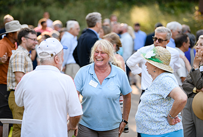 smiling guests at a party in the mcbride aquatic garden