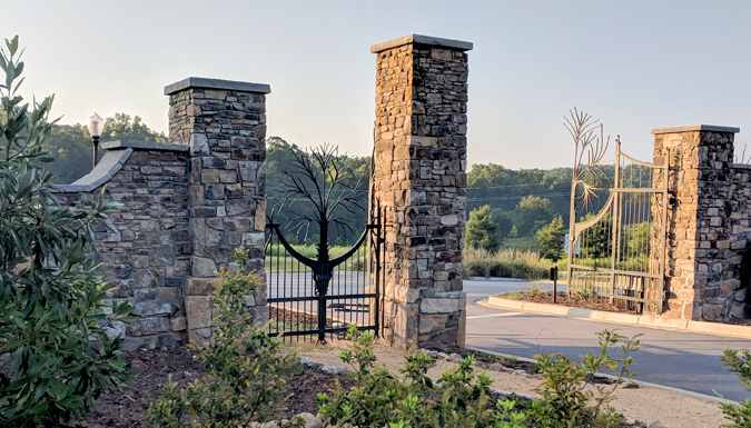decorative stone wall and iron gate entrance to the botanical garden
