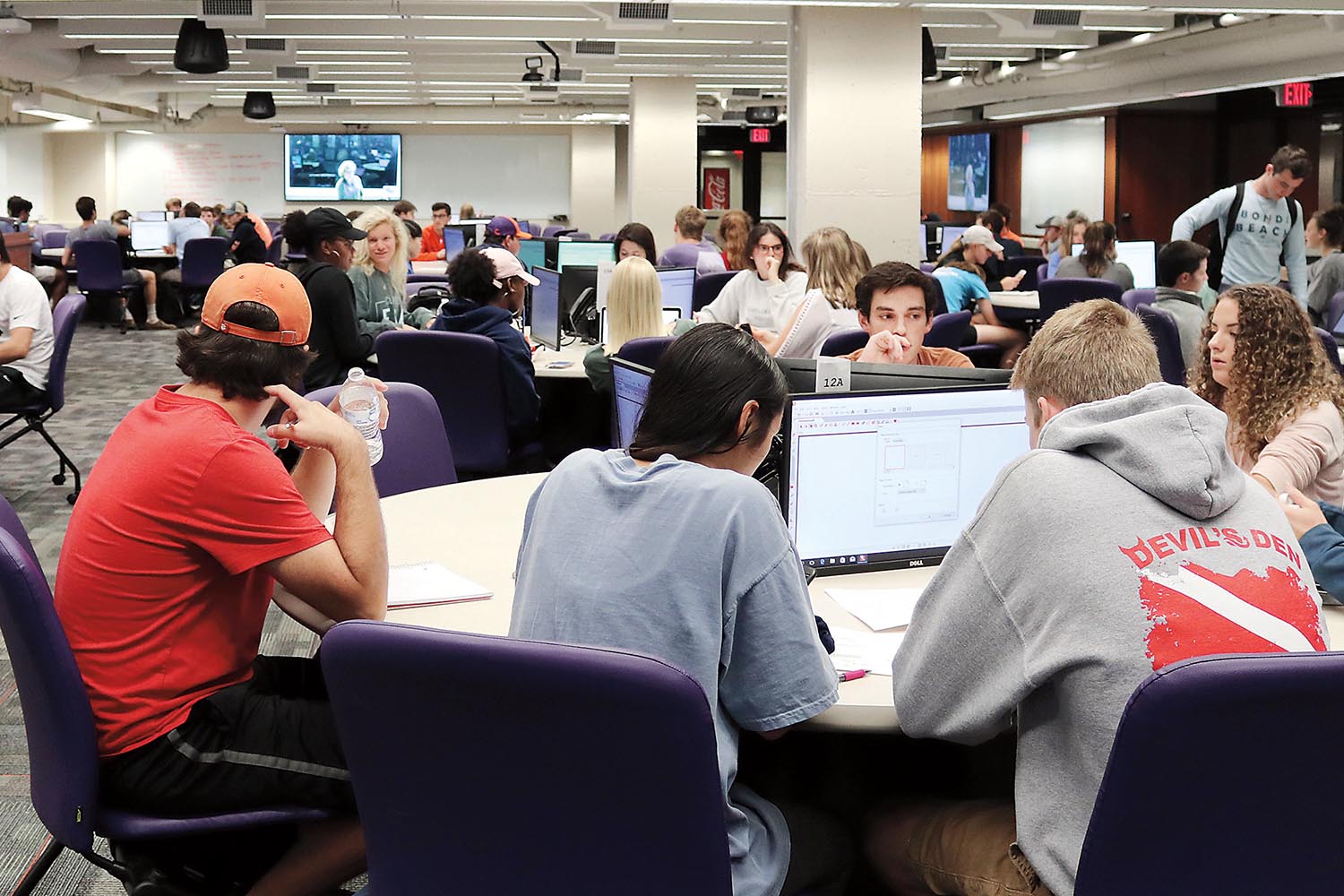 The SCALE-UP classroom is equipped with 16 tables that each seat nine students. Every table also has three interactive monitors.