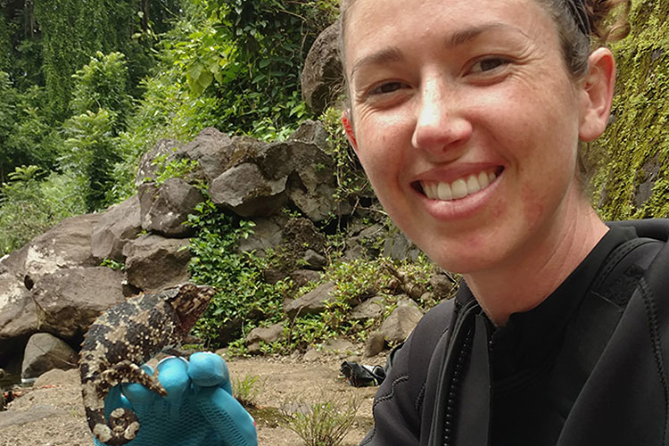 Woman holding lizard.