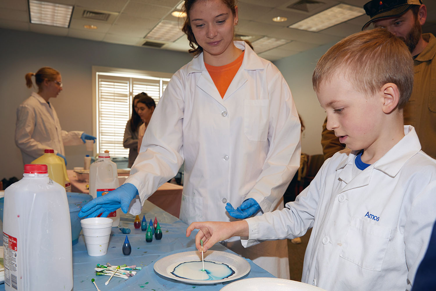 Girl and young boy conducting science experiment.