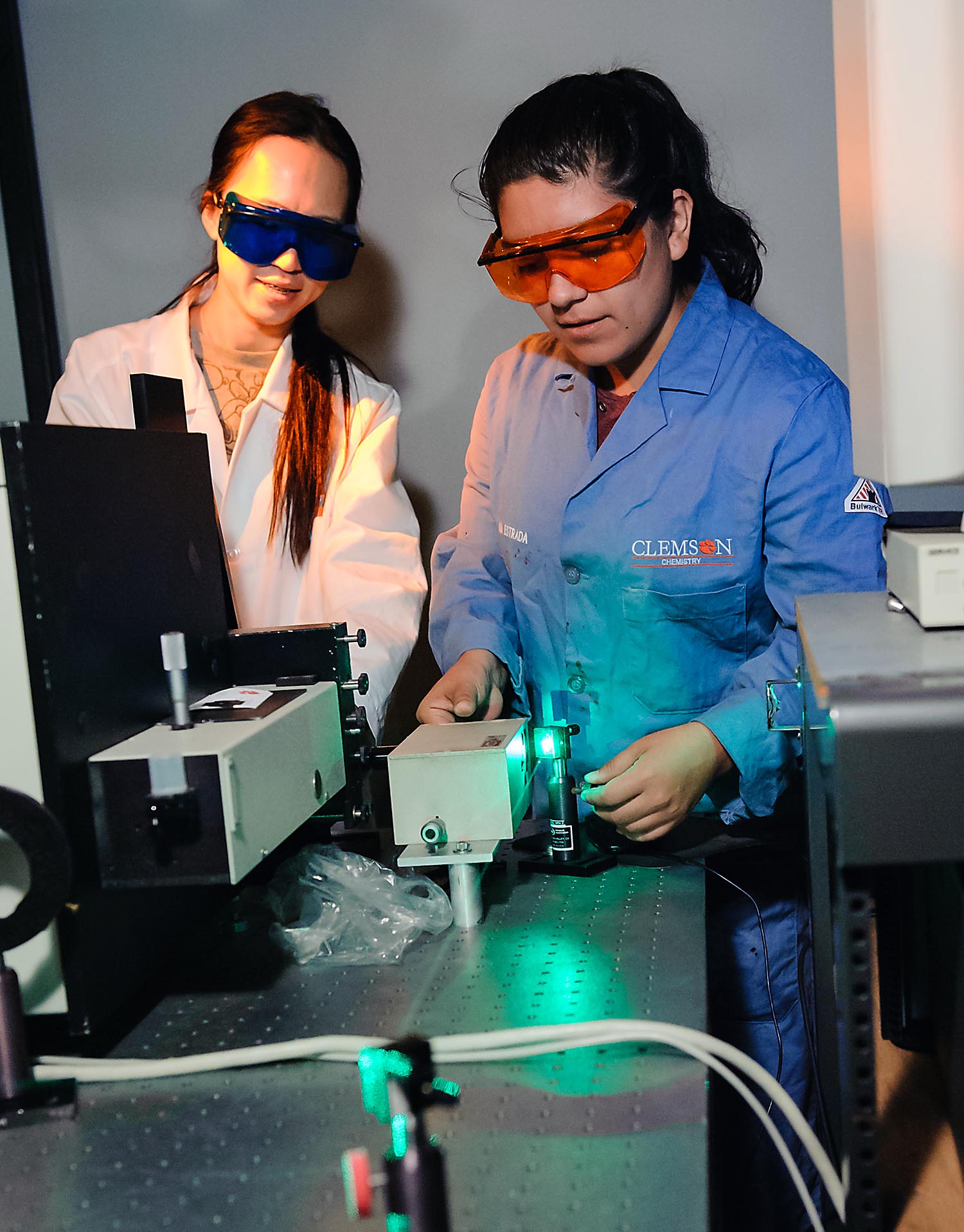 Two women working in lab with laser.