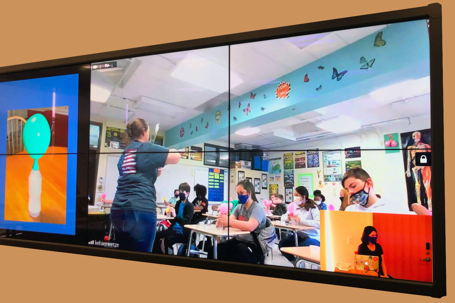 Wall of screens showing a virtual outreach class being taught.