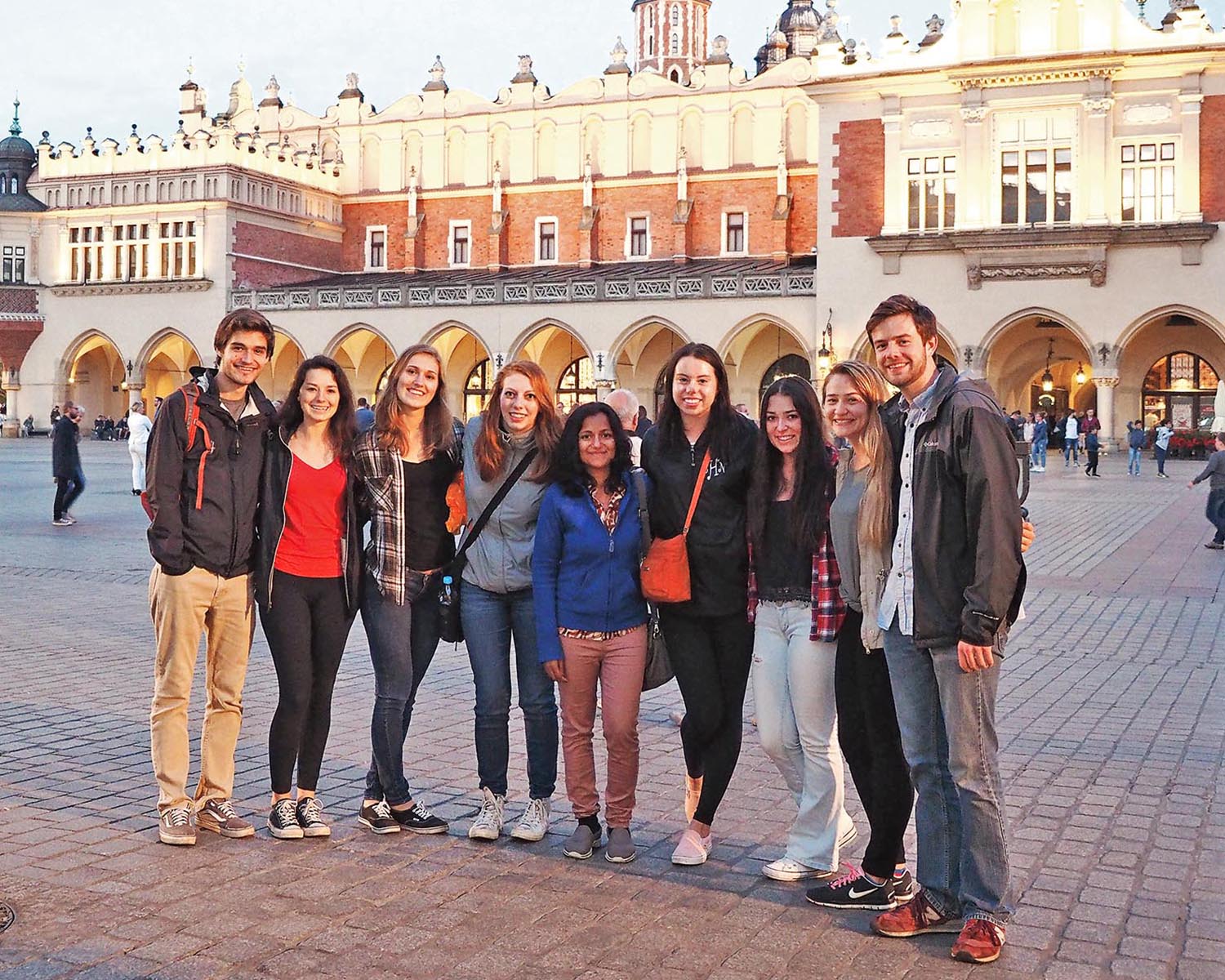 Group of students abroad, standing in a courtyard.