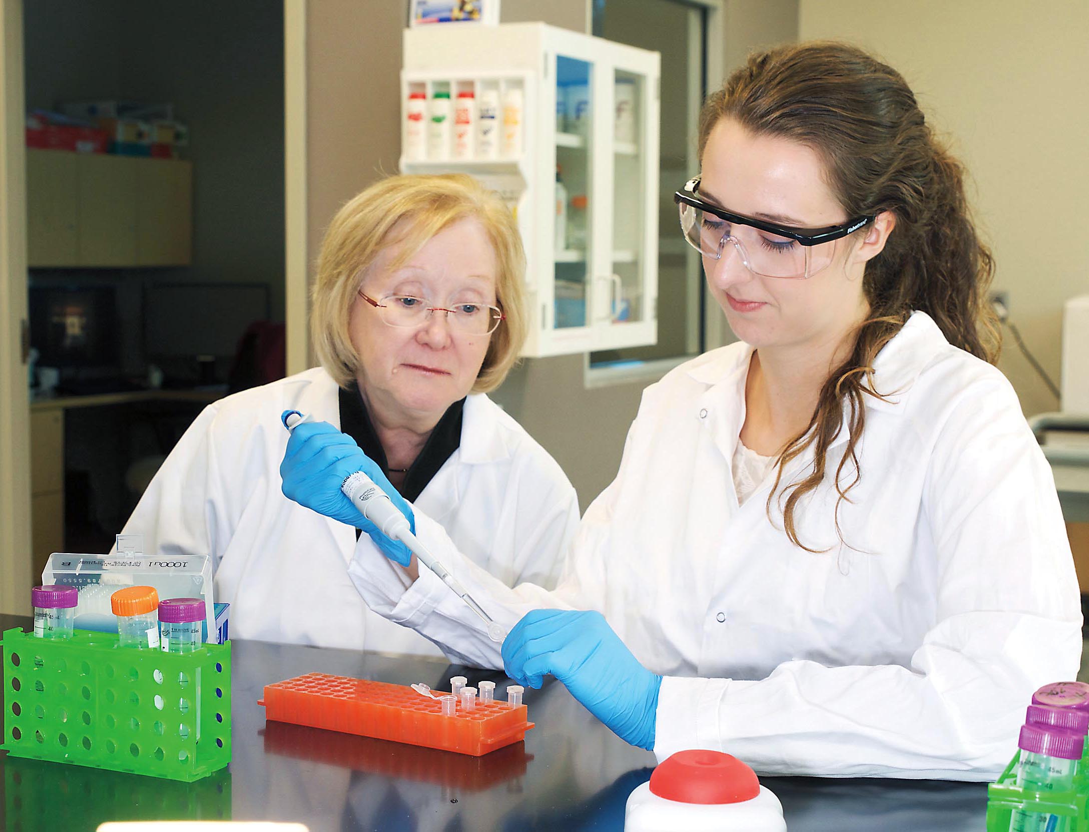 Student and professor working together in lab.