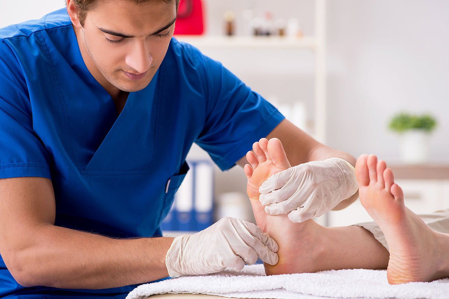 Podiatrist checking patient's feet.