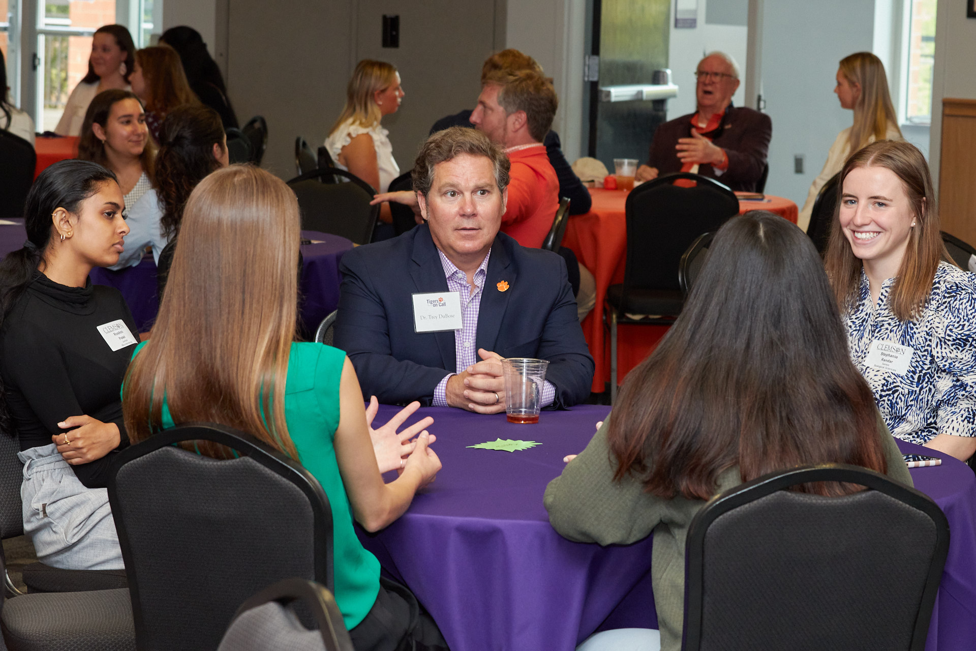 A roundtable at Tigers on Call with students and an alumnus.