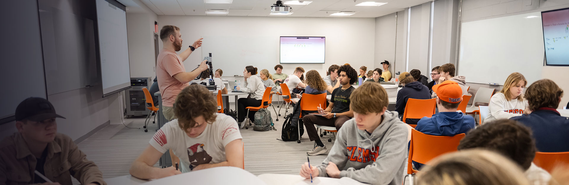 Math professor lecturing to full class