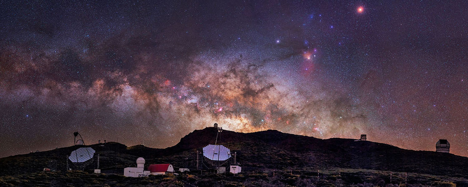 Telescopes, satellite dishes, starry sky at night.
