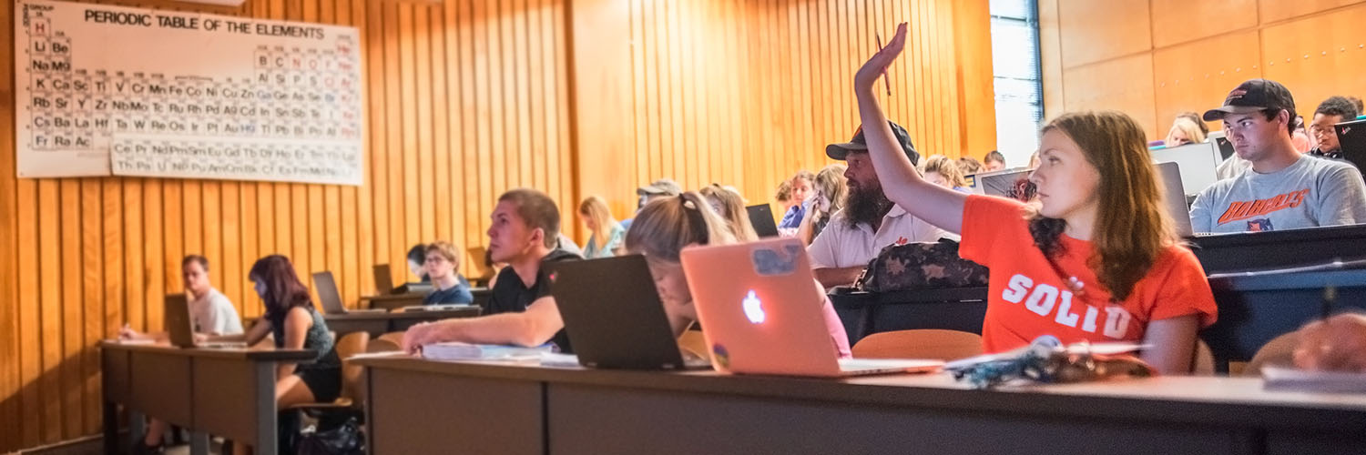 Class with students, one raised hand.