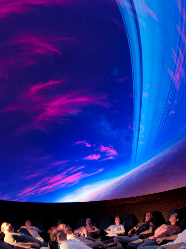 People in a planetarium watching a show.