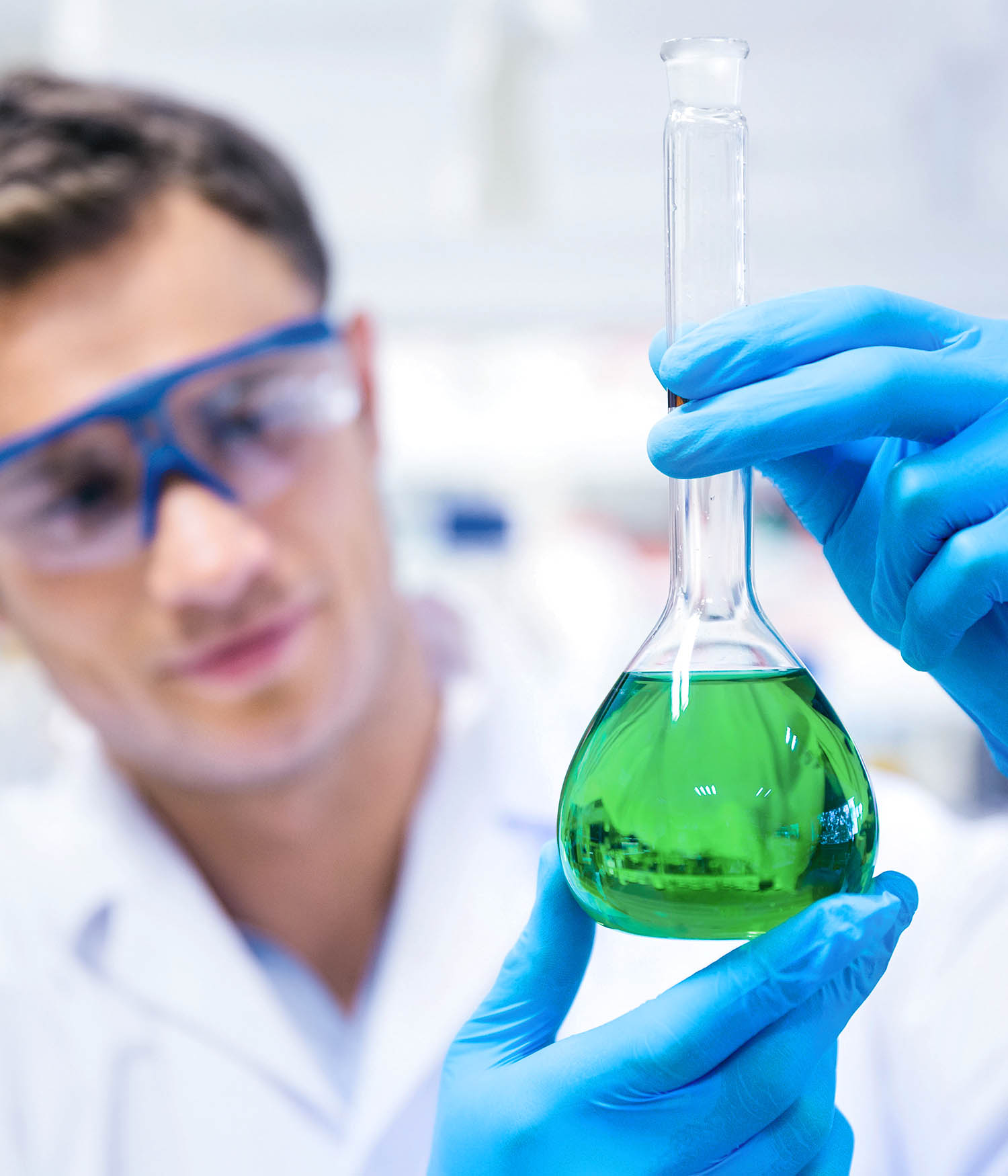 Student in lab holding beaker