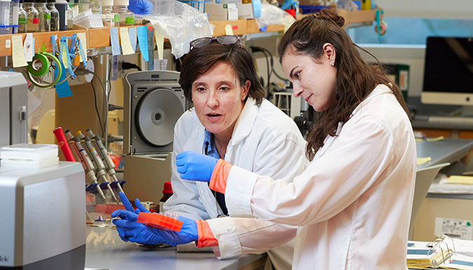 Student and faculty member working together in lab.