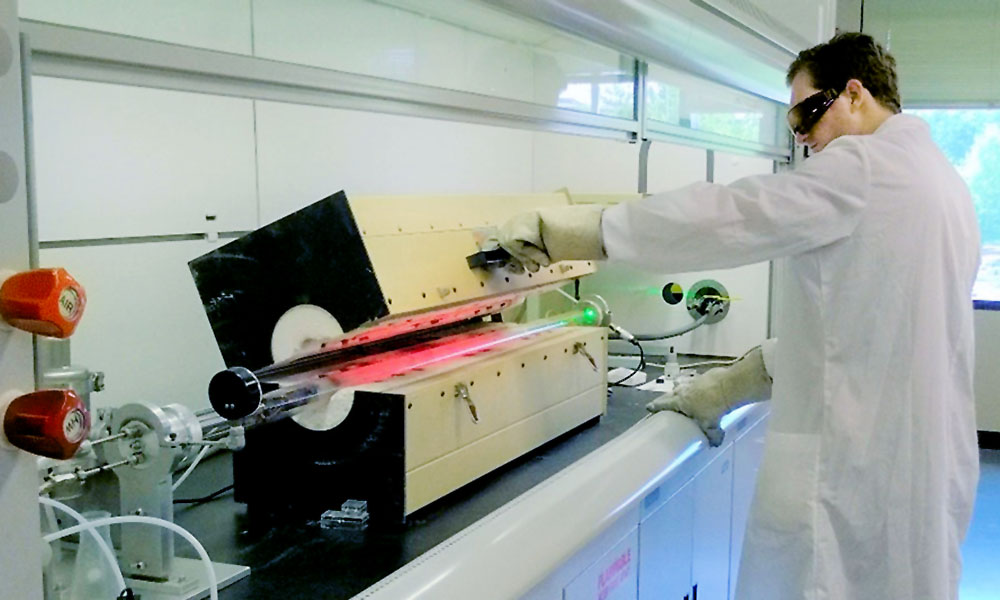 Researcher working with equipment in lab.