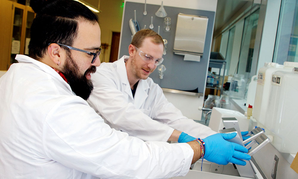 Two people working in a lab.