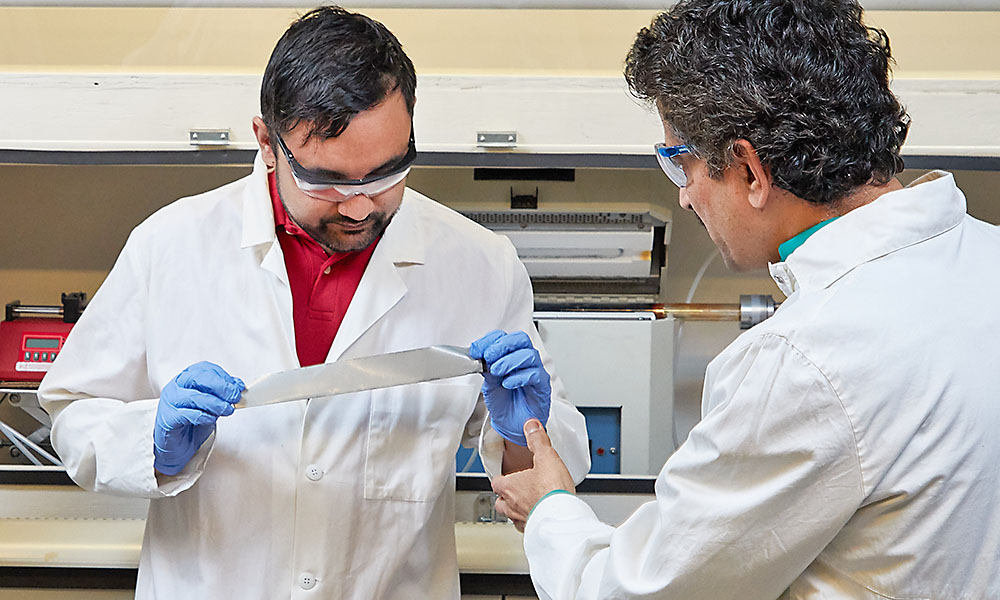 Student and professor in AMRL lab examining material.