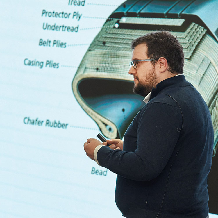 Man presenting in front of video wall.