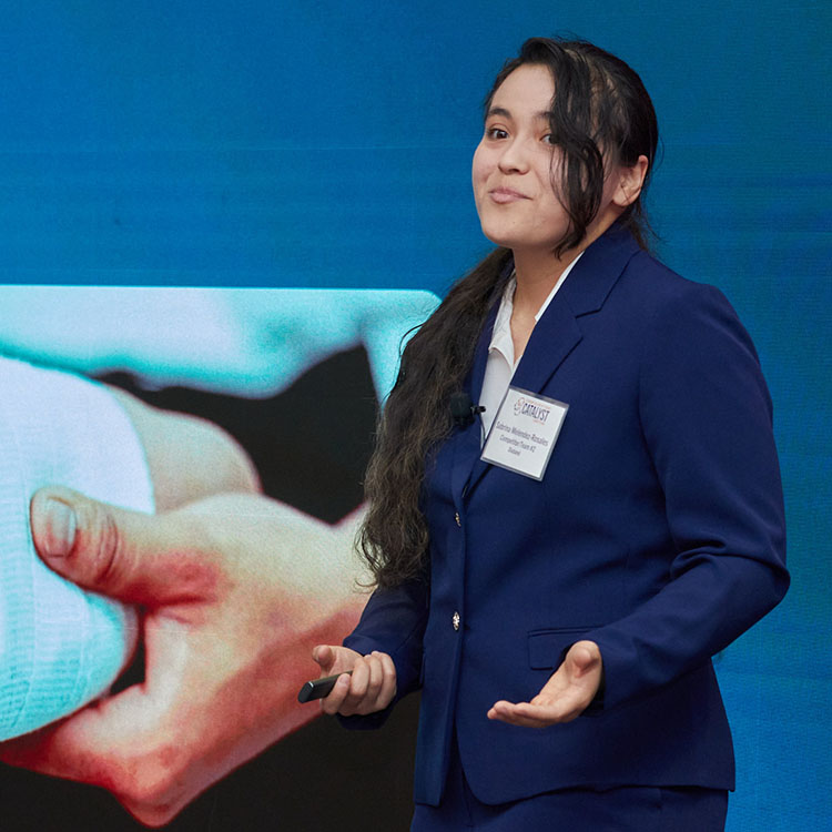 Girl giving presentation in front of display wall.