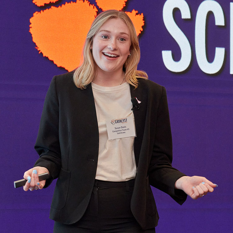 Girl in front of display wall giving presentation.