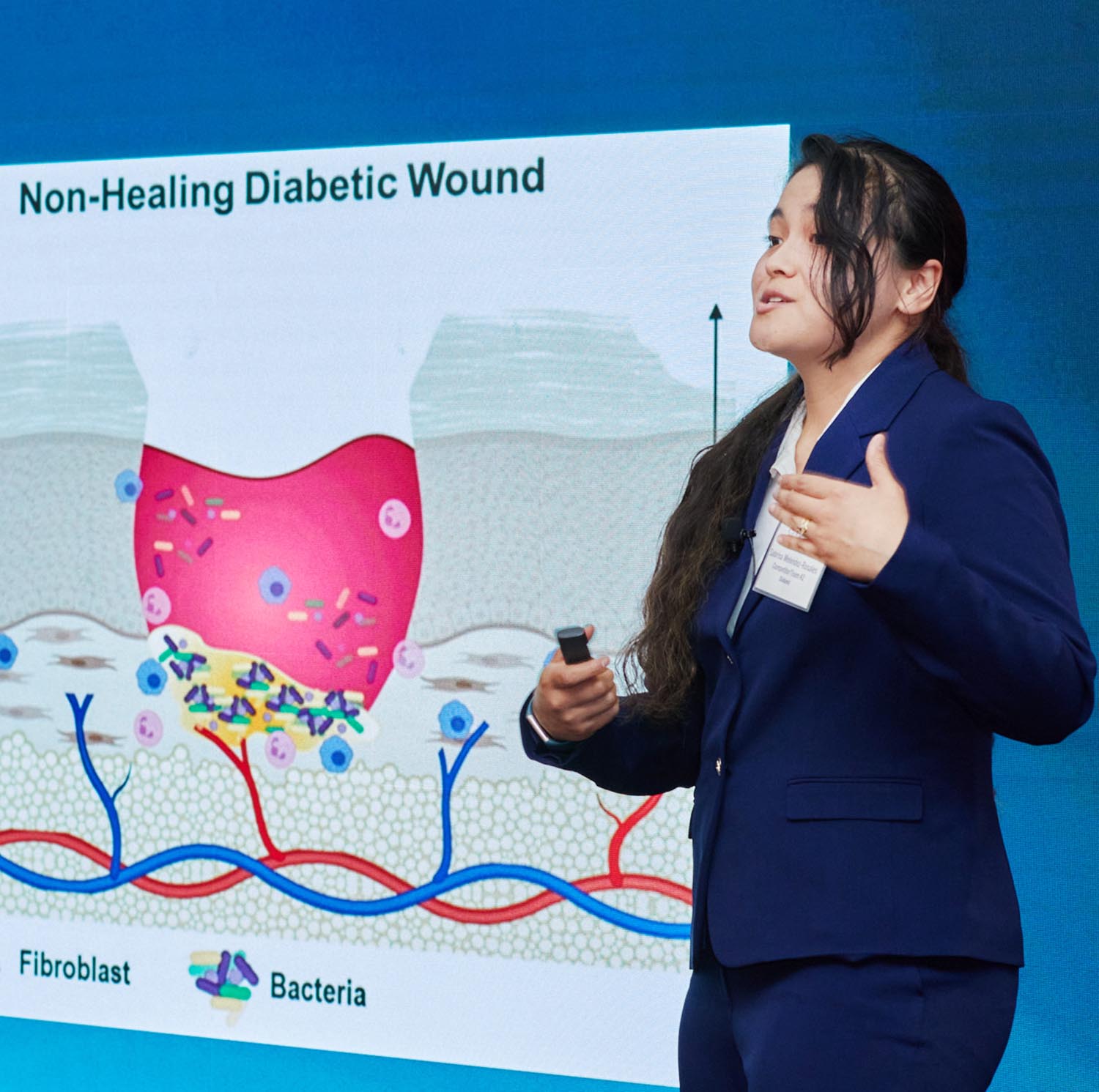 Girl giving presentation in front of video wall.