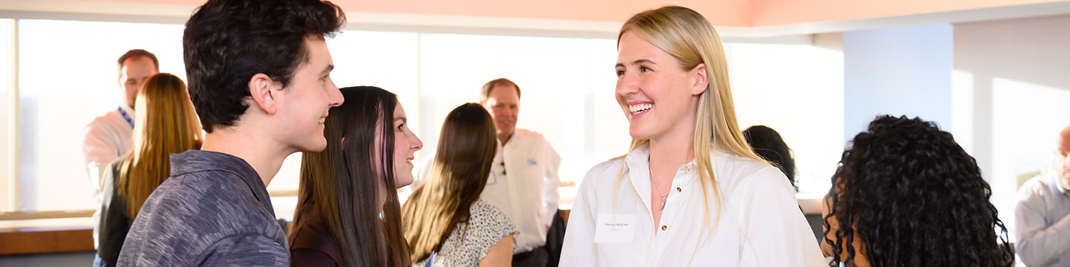 Woman talking to others at a business meeting.