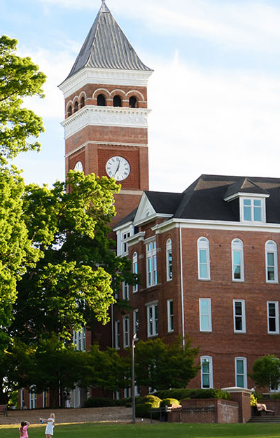 Tillman Hall bell tower with trees during the summer