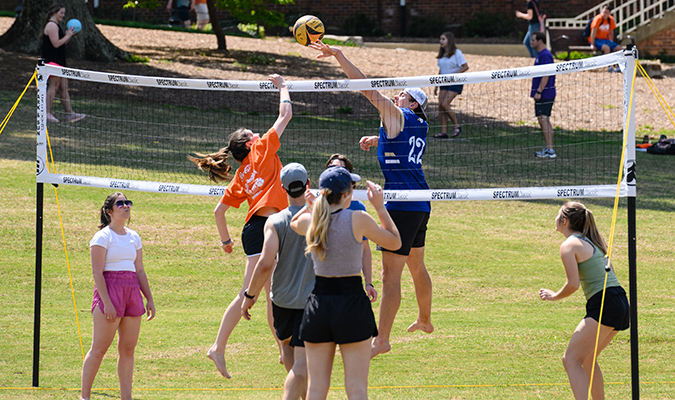 Students playing volleyball on Bowman Field