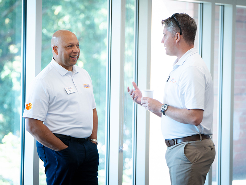 Two parents from the Clemson Family Ambassador Board in discussion