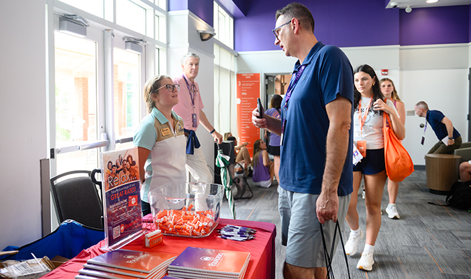 Clemson student interacting with 9 Rounds Staff