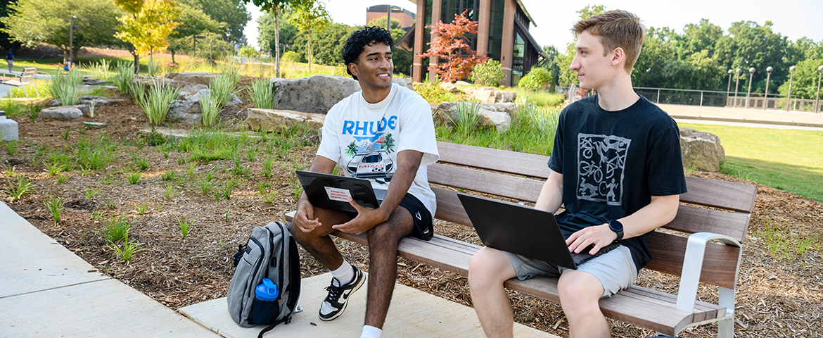 A student in conversation with Clemson Staff