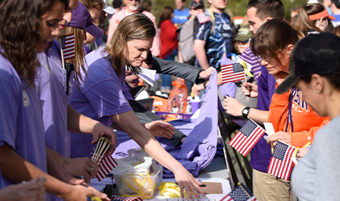 Students interacting with families at Military Walk for Veterans