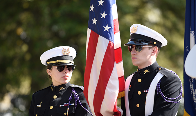 Clemson students holding Flag at Clemson Scroll of Honor
