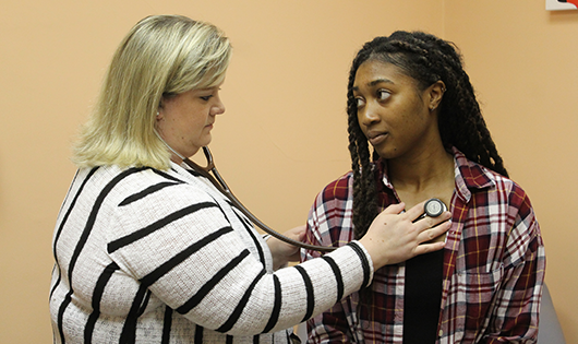 Student getting examined at Redfern Health Center