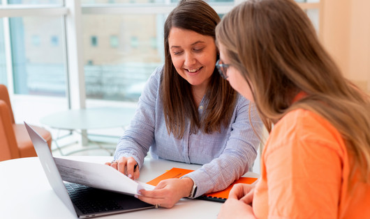academic advisor talks with a student