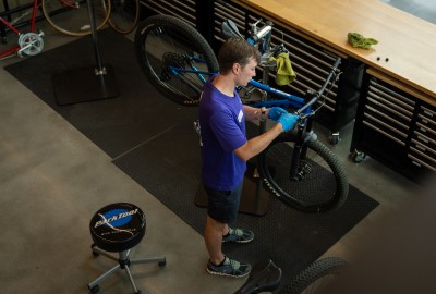 bike maintenance shop employee working on a bike