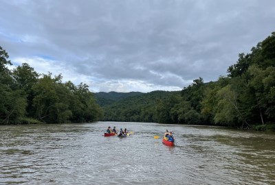 students canoeing on a river