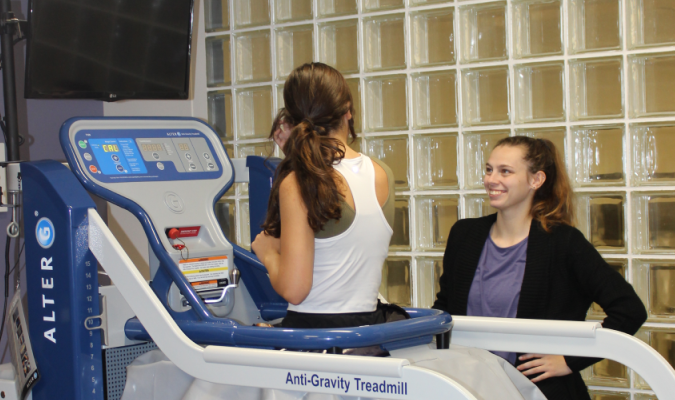 Student on alter-g treadmill with physical therapist
