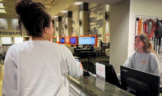 student scanning ID at Fike front desk