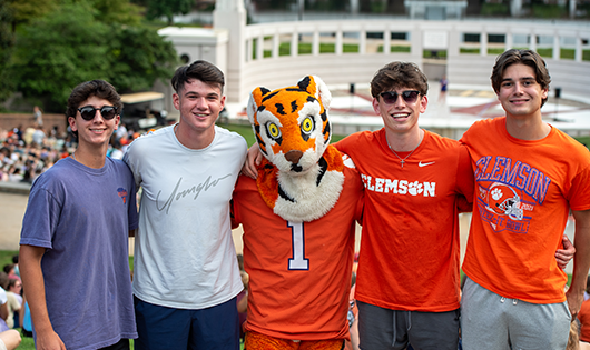 Clemson students taking picture with Tiger mascot at the Welcome Week Rally, Clemson University, South Carolina