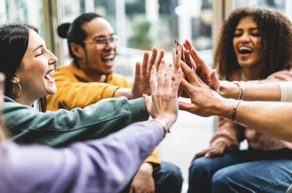 A group of students in circle joining hands