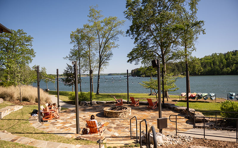 A vibrant Clemson campus scene featuring students relaxing at the Quattlebaum Outdoor Center