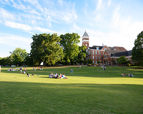 Vibrant Clemson campus with people enjoying the outdoors on a summer day