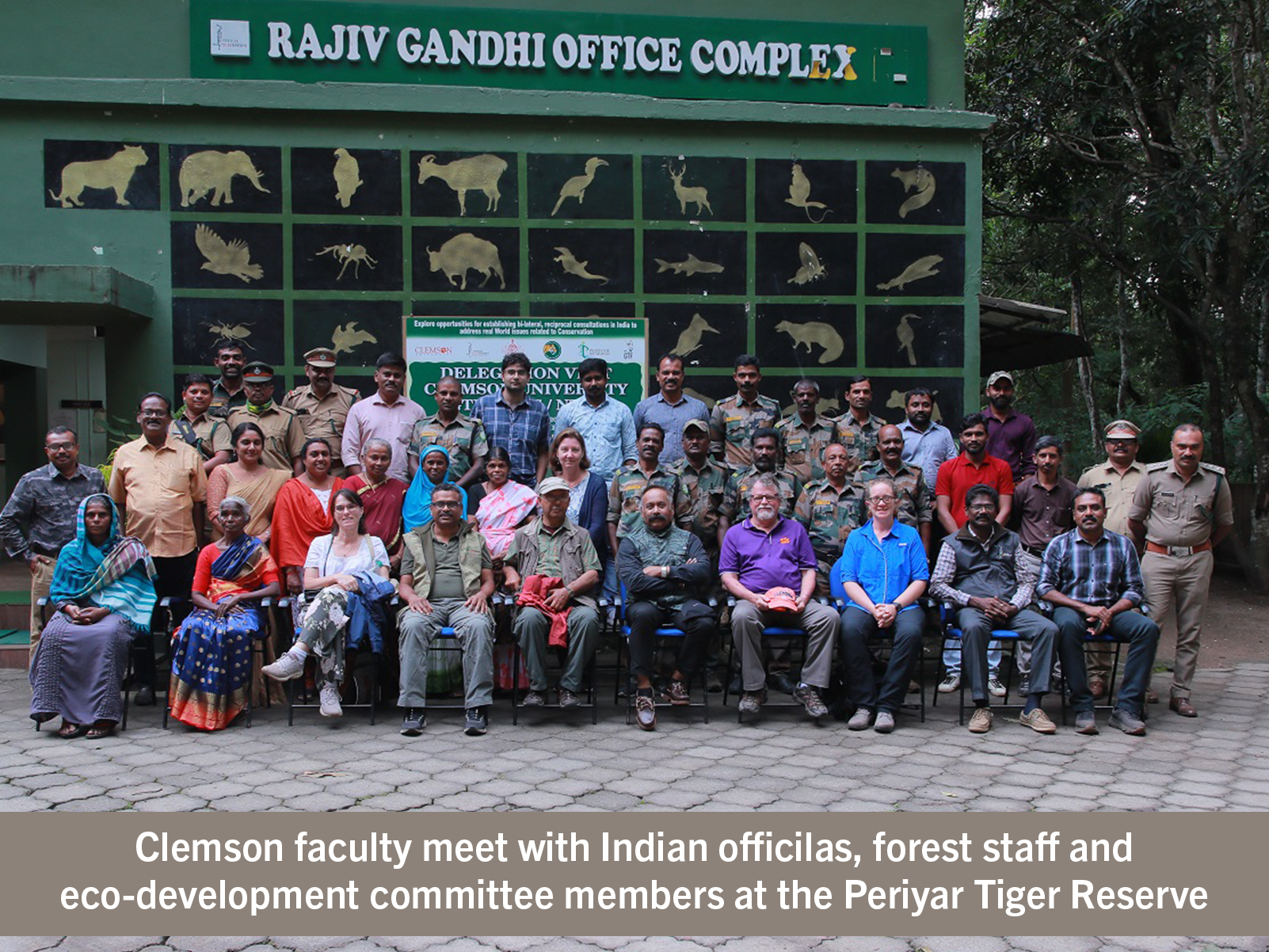 A group poses for a photo outside the Rajiv Gandhi Office Complex